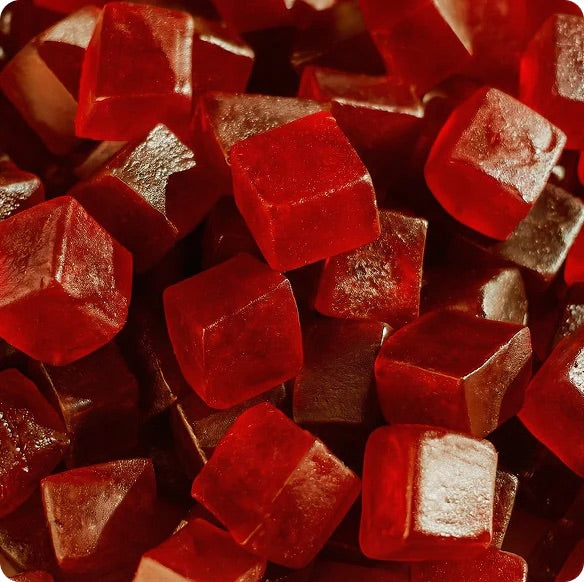 Close-up of red gummy bears with a dark background