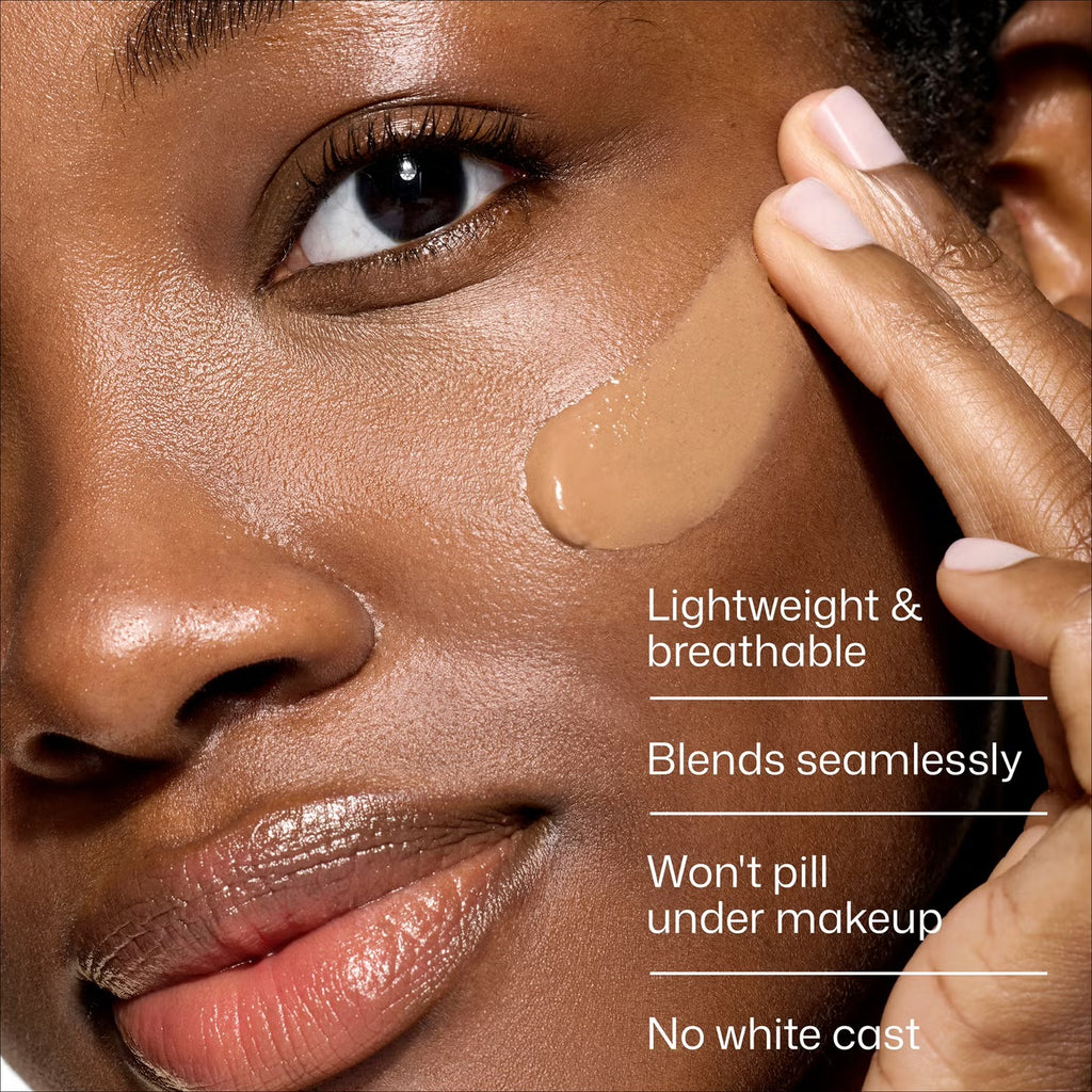 Close-up of a model applying liquid foundation to their cheek, with text overlays highlighting product benefits: 'Lightweight & breathable', 'Blends seamlessly', 'Won't pill under makeup', and 'No white cast'.